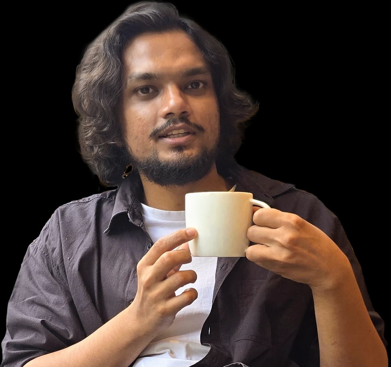 Mayank Bagchi holding a cup of chai.